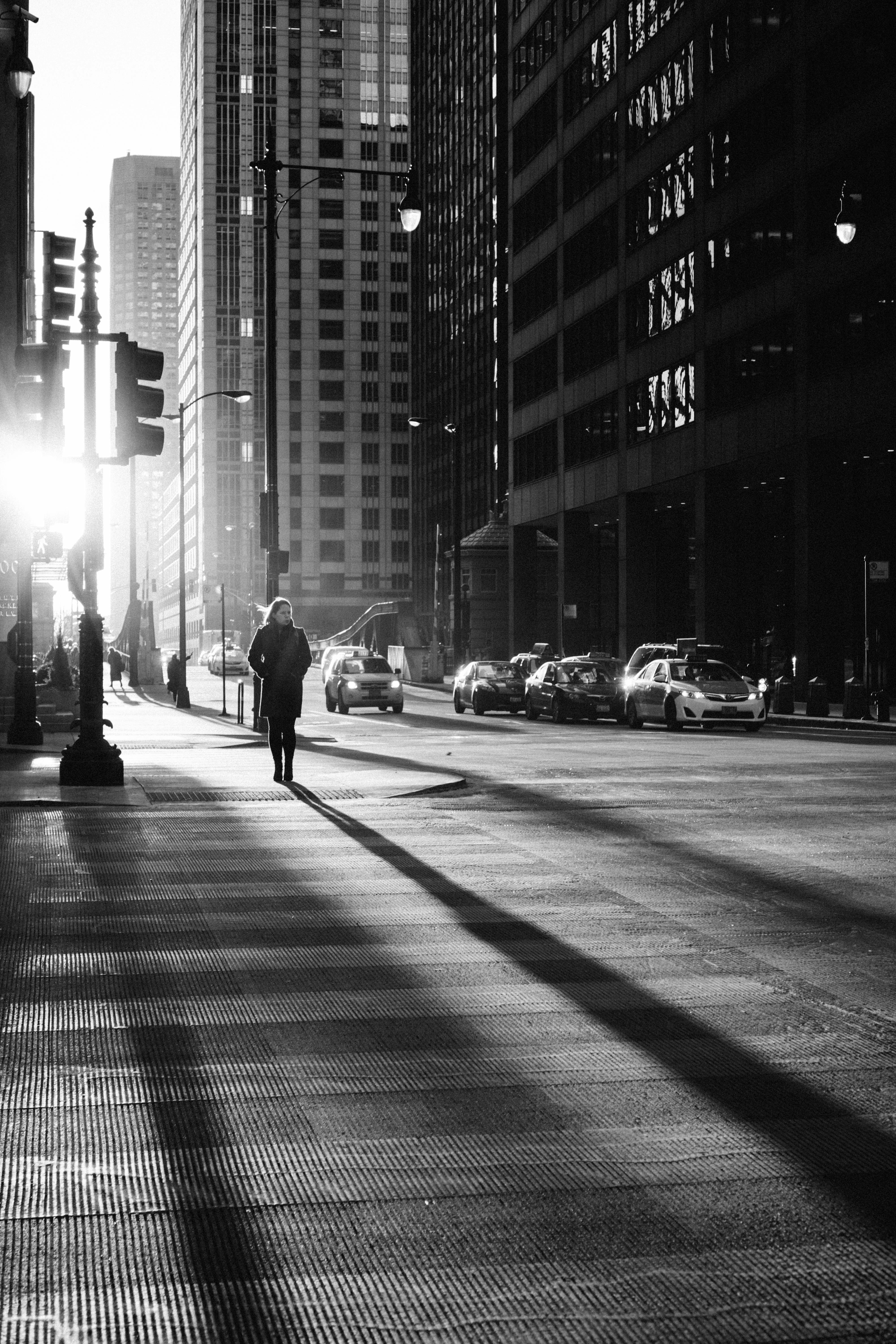 Person walking past urban architecture